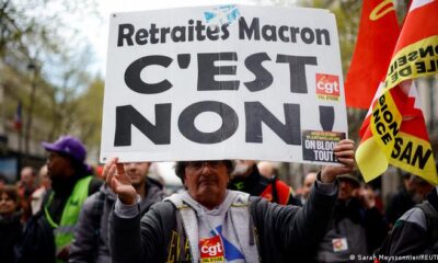A protester in Paris, France, holds a placard that reads Macron's pension - no! up