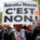 A protester in Paris, France, holds a placard that reads Macron's pension - no! up