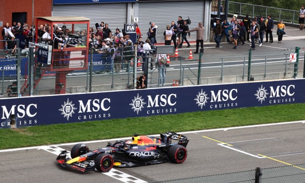 Max Verstappen takes the chequered flag at Spa-Francorchamps.