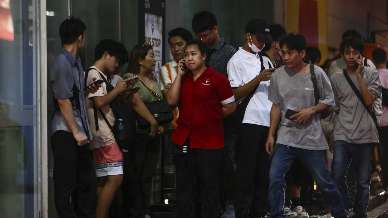 People gather outside the mall in the Thai capital.