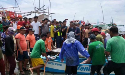 Survivors arrive ashore in the province of Pangasinan on October 3 after a collision in the South China Sea.