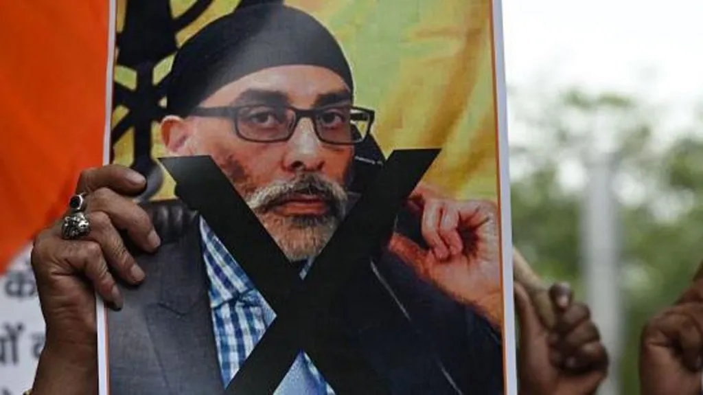 Getty Images A protester holds a banner depicting Gurpatwant Singh Pannun, a US-Canadian lawyer designated as a Khalistani terrorist by Indian, during a rally in Delhi on September 24, 2023