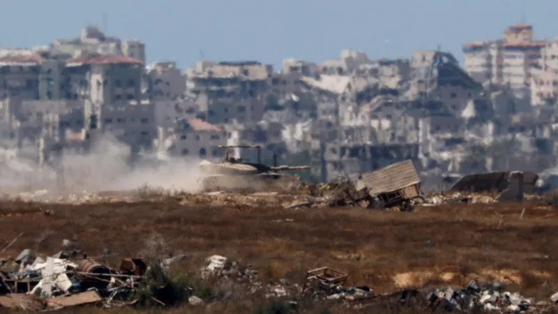 Reuters An Israeli tank manoeuvres inside the Gaza Strip, as seen from Israel (17 June 2024)