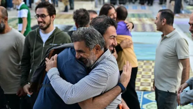 Getty Images Groups of men embracing one another to celebrate Eid