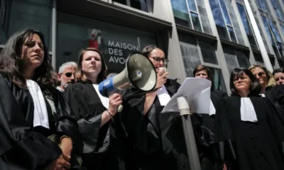 OLIVIER CHASSIGNOLE/AFP Vice-President of the Lyon Court Bar Sarah Kebir (C) delivers a speech with a megaphone